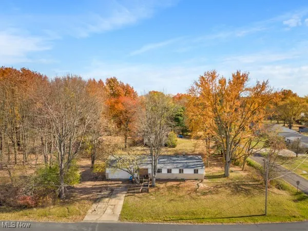View of property's community featuring driveway and a lawn