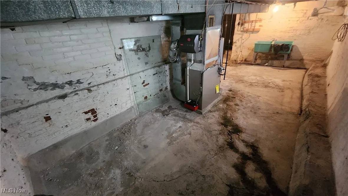 View of unfinished below grade area with stair way to exterior  walk out