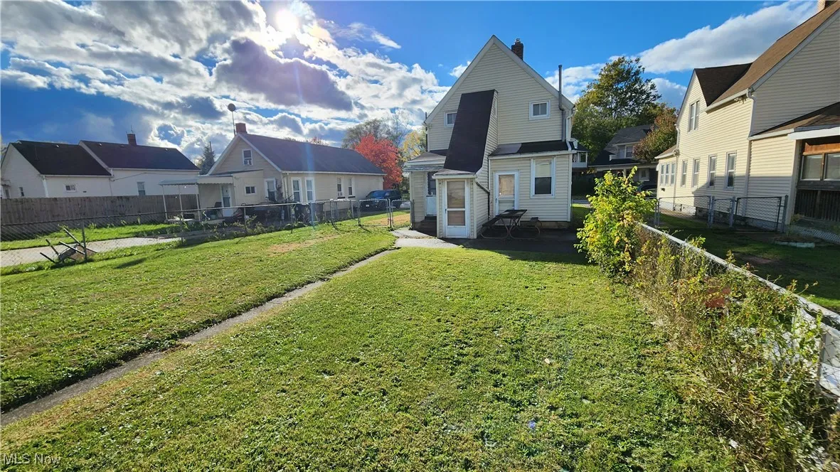 Back of home with yard view