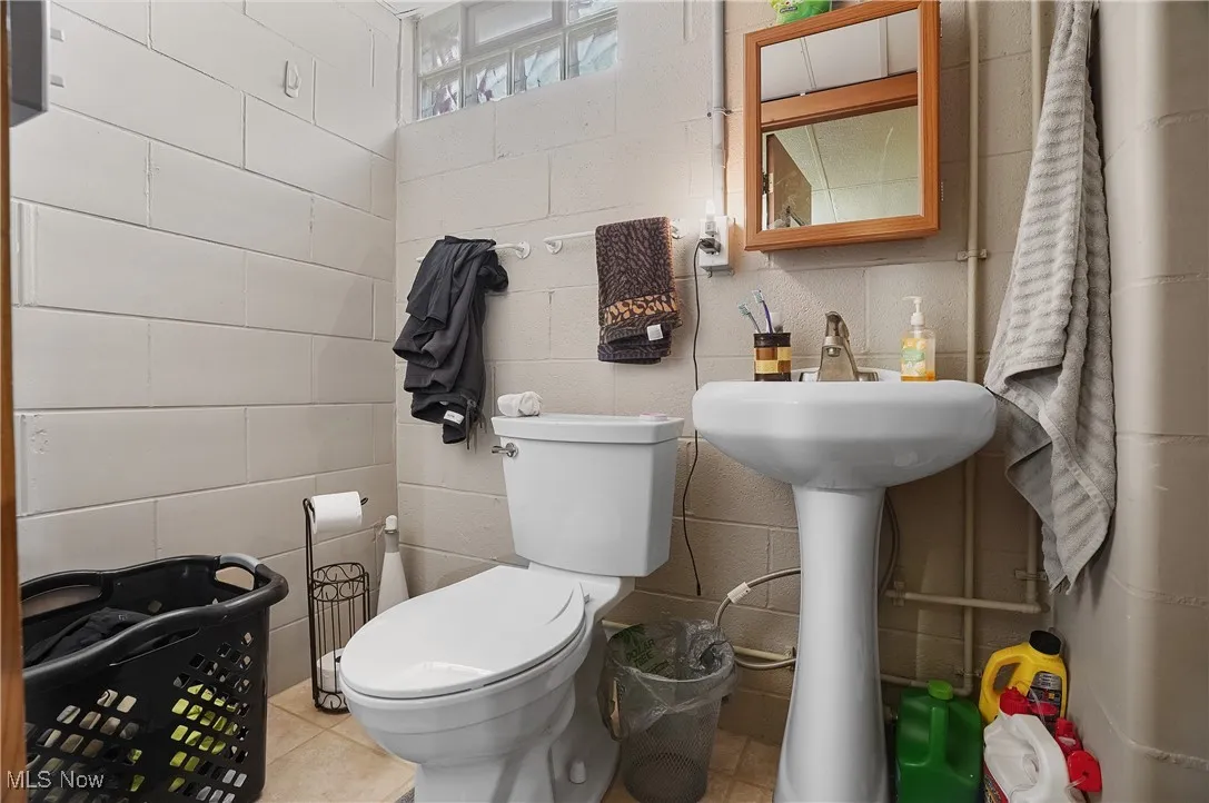 Bathroom with toilet and tile patterned flooring