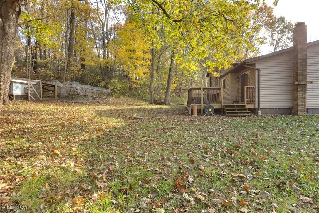 View of green lawn with a deck
