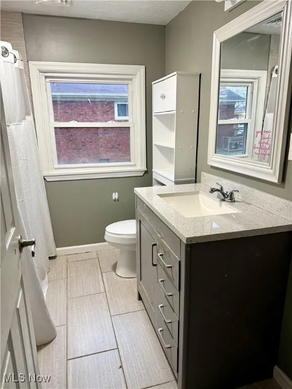 Bathroom featuring vanity and curtained shower