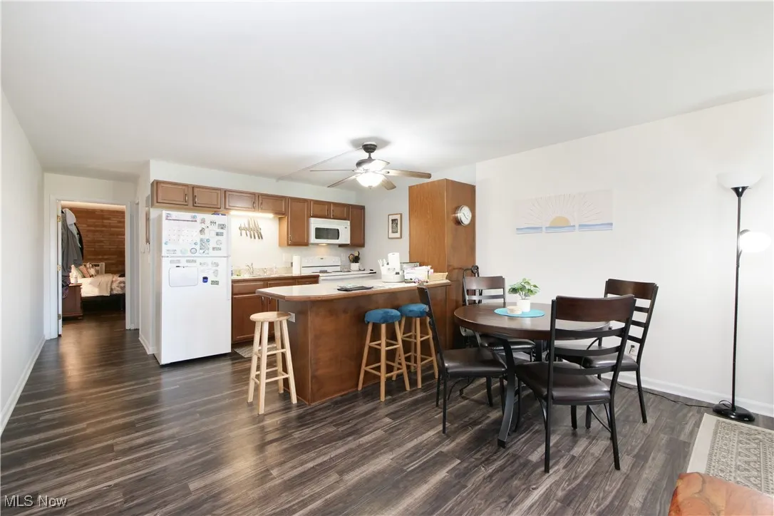 Dining space featuring dark wood finished floors and ceiling fan