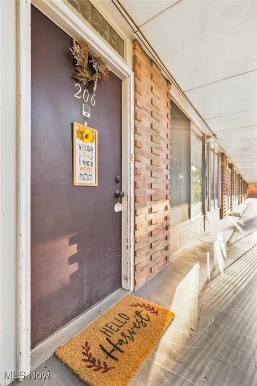 Property entrance featuring brick siding