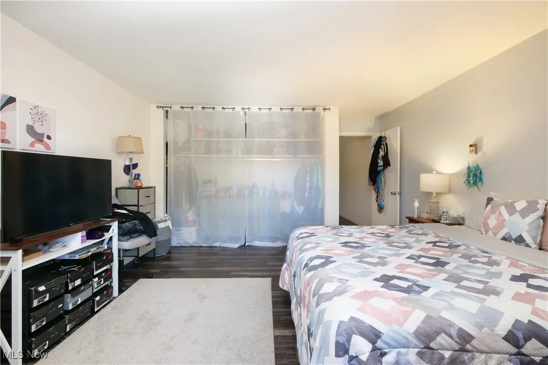 Bedroom with dark wood-style flooring