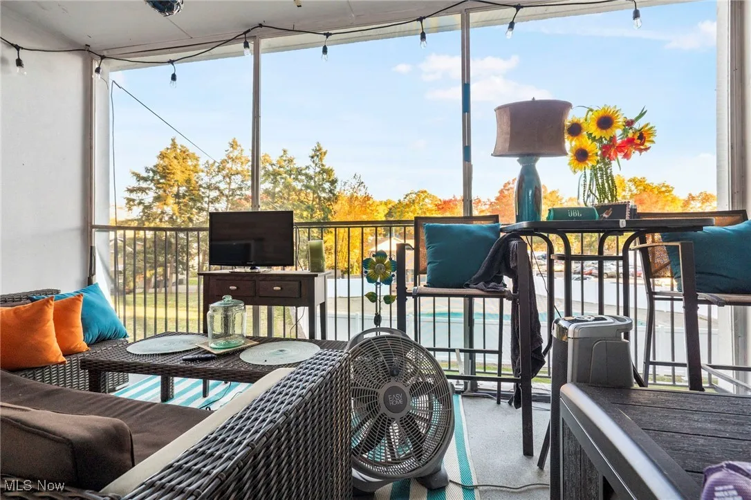 Sunroom / solarium featuring a balcony and healthy amount of natural light