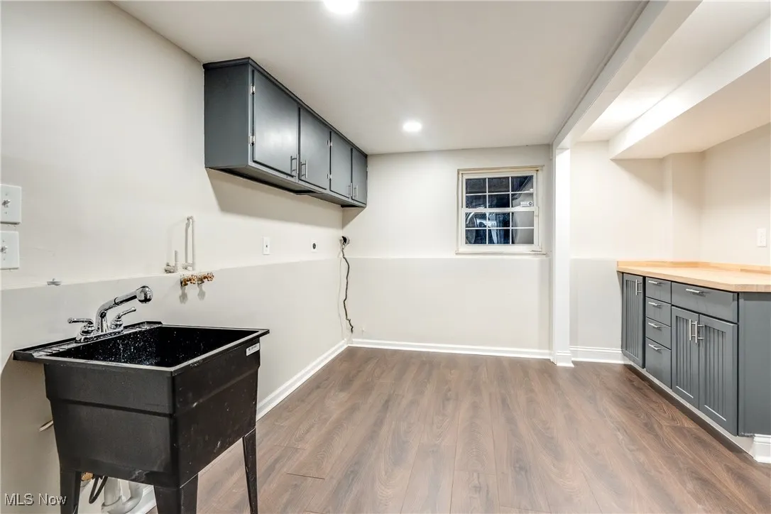 Laundry area with cabinet space, hookup for a washing machine, dark wood-style flooring, and recessed lighting