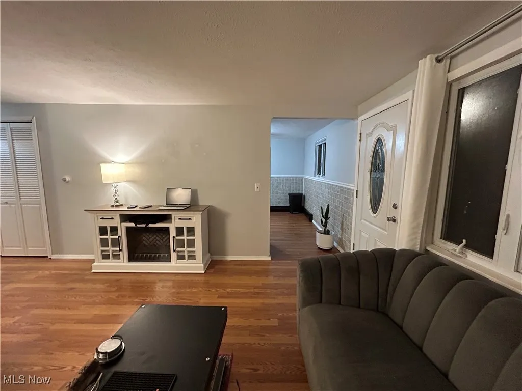Living area with wood finished floors and a textured ceiling