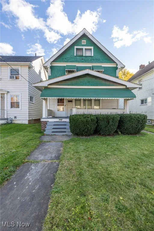 View of front facade with a porch and a front lawn