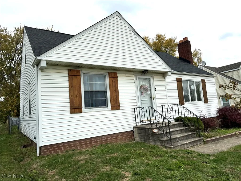 View of front of home featuring a chimney