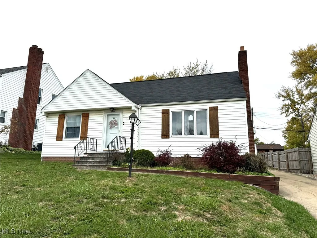View of front of home with a front lawn and a chimney