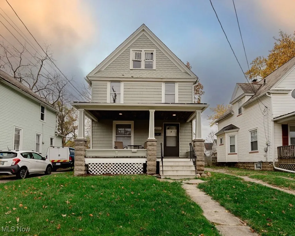 Traditional style home featuring a front lawn and a porch