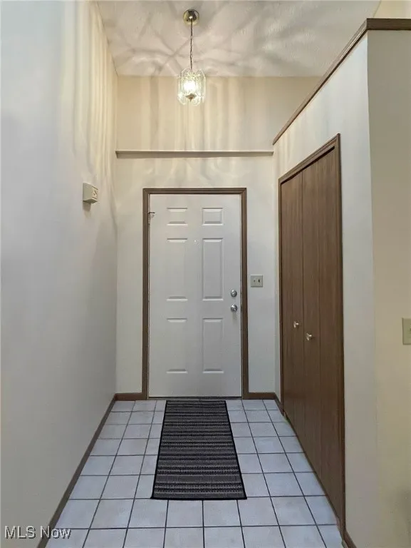 Entrance foyer with skylight and pretty light fixture.