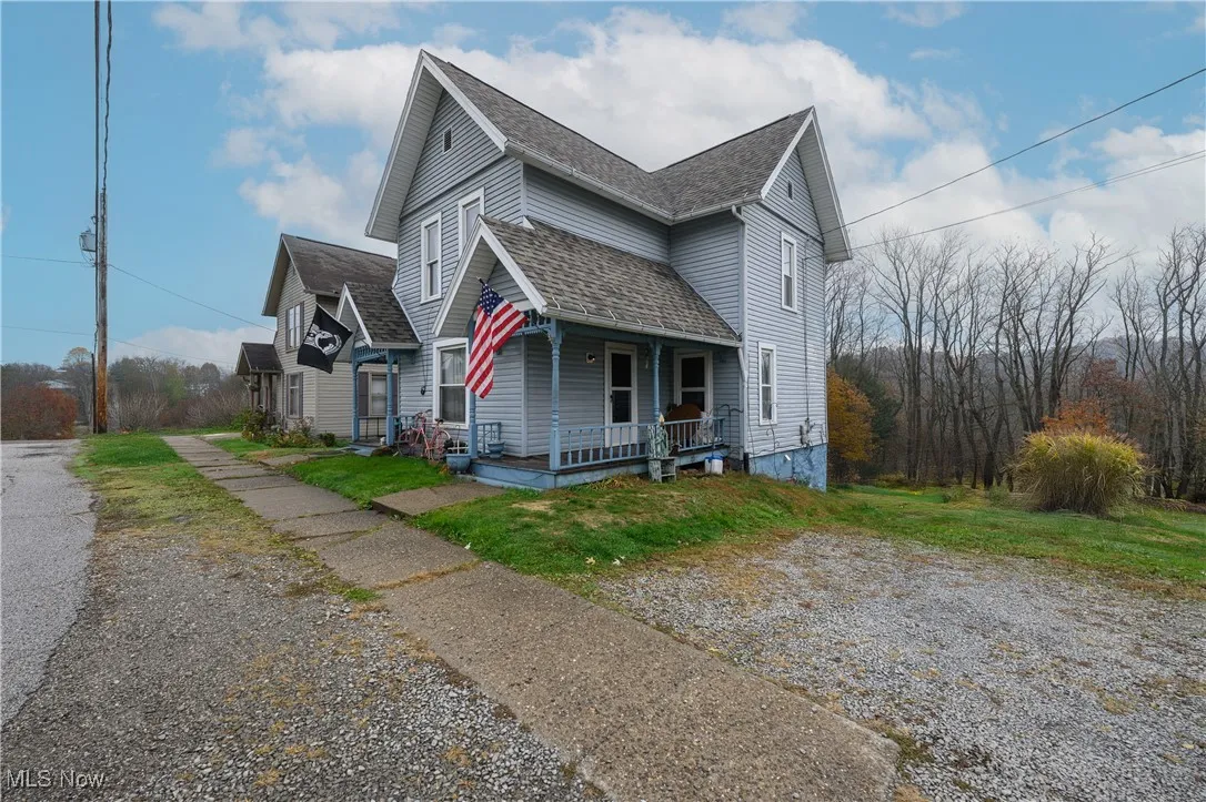 View of front facade with a porch and a front lawn