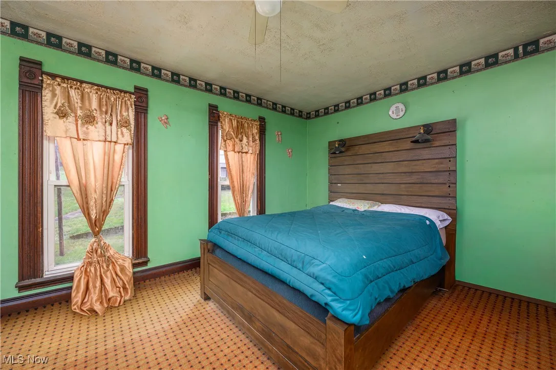 Bedroom featuring a textured ceiling and ceiling fan