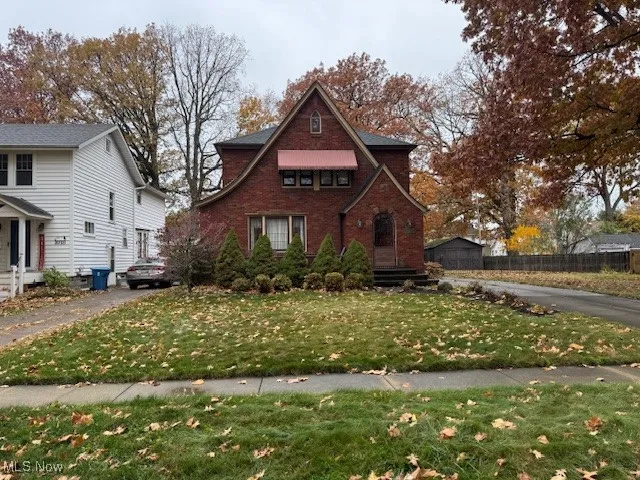 View of front of home with a front yard and brick siding