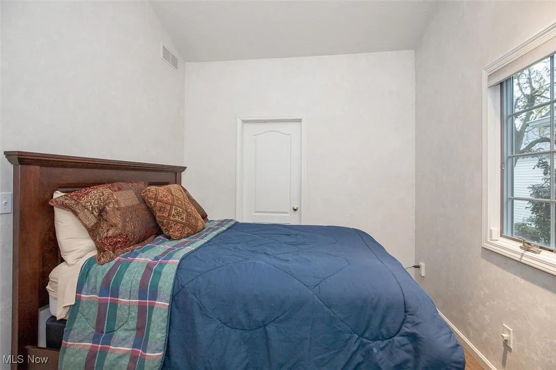 Bedroom with baseboards and a textured wall