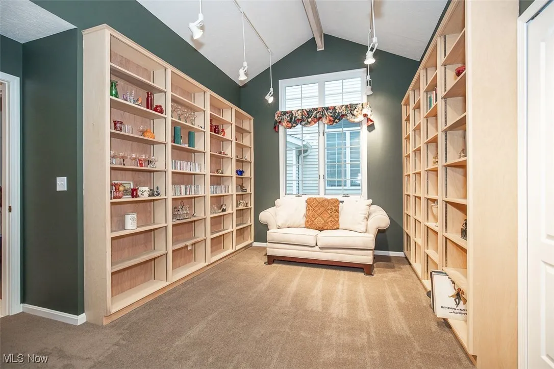 Living area with carpet and baseboards
