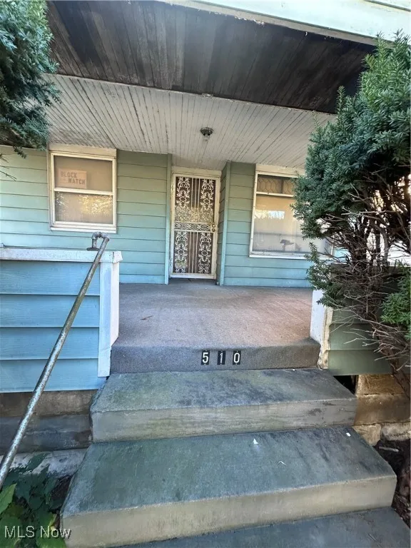 Entrance to property featuring a porch