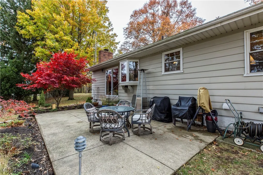 View of patio with a grill and outdoor area with great park like views