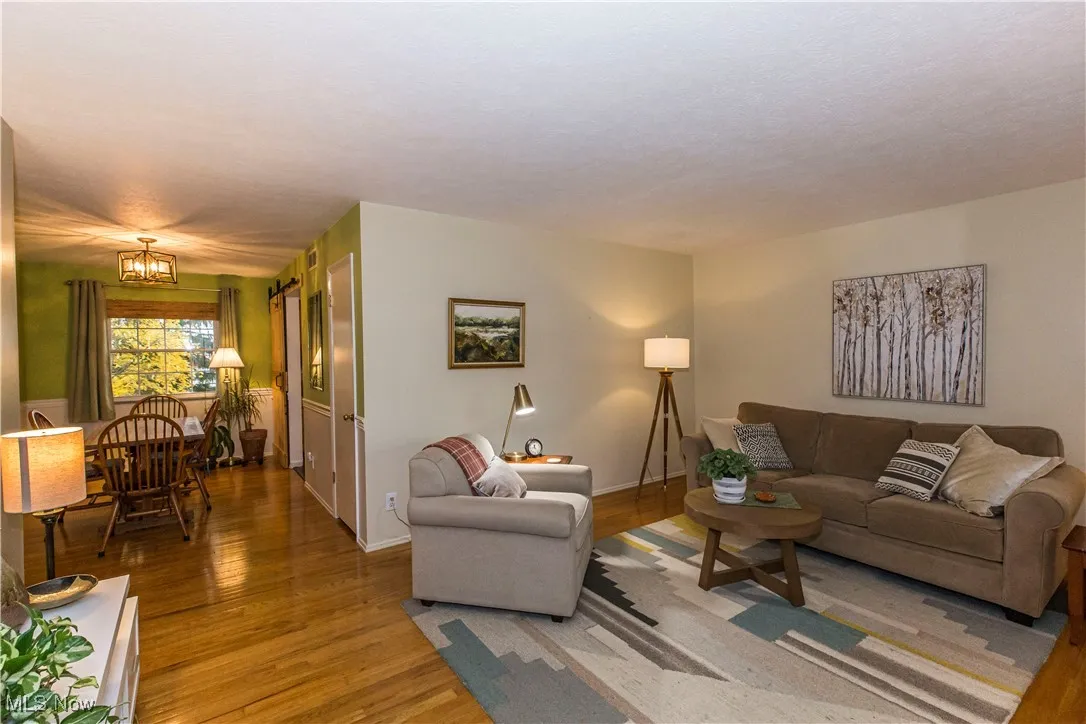 Living area featuring wood finished floors and a chandelier