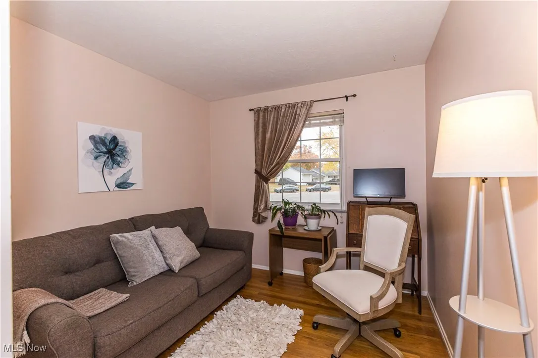 Living area with wood finished floors and baseboards