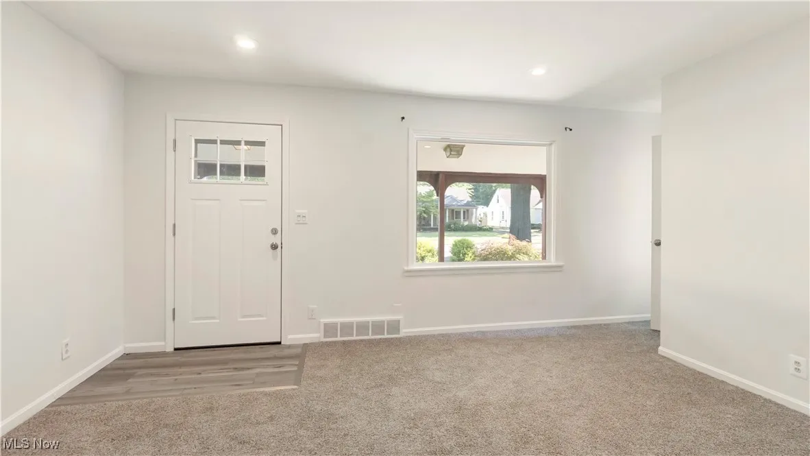 Entryway featuring light carpet and recessed lighting