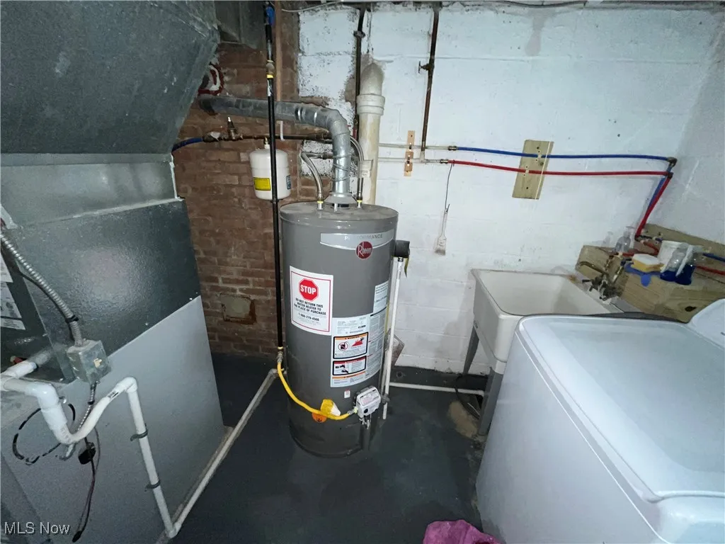 Utilities featuring washer / dryer, gas water heater, and heating unit