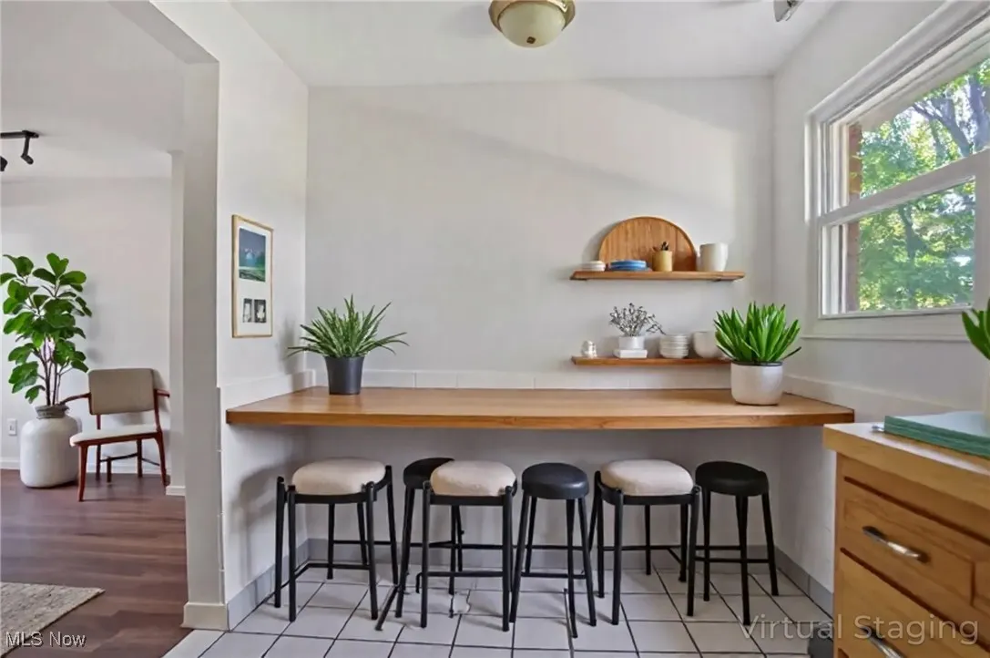 Bar area with open shelves and light wood-style flooring