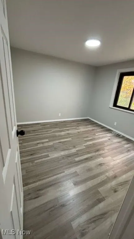 Spare room featuring wood finished floors and recessed lighting