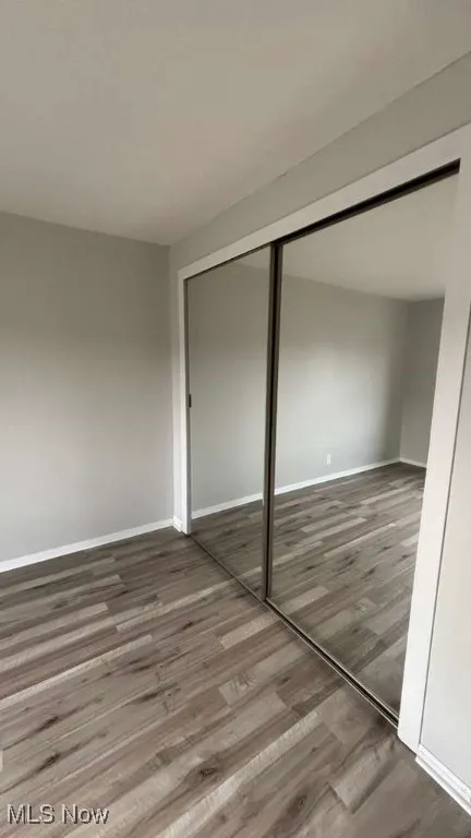 Unfurnished bedroom with light wood-type flooring and a closet