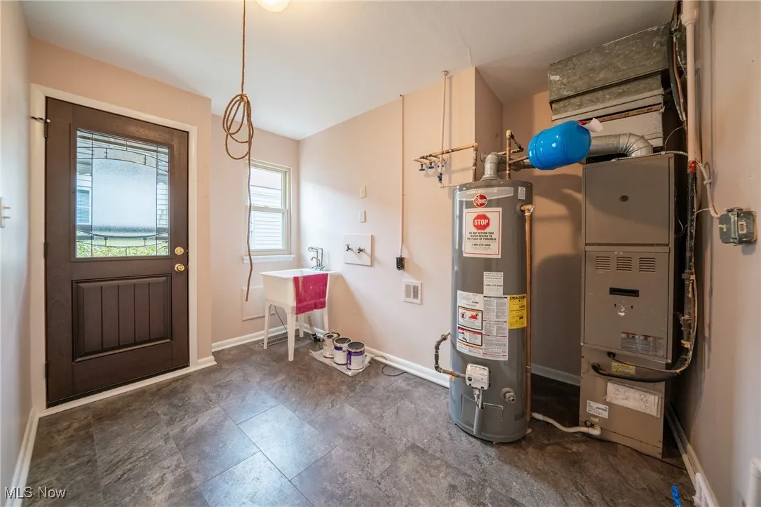 Utility room with gas water heater and heating unit