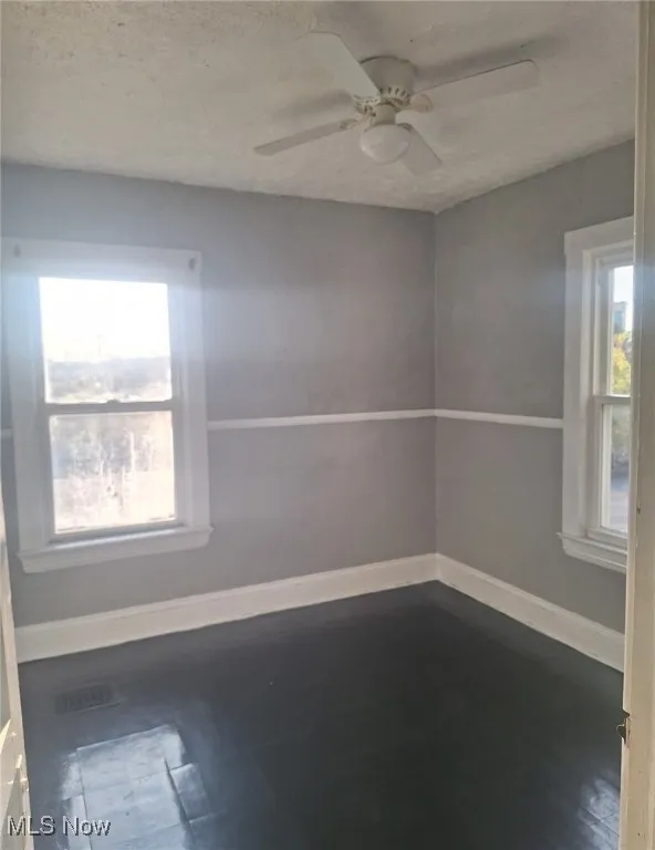 Spare room featuring a textured ceiling and ceiling fan