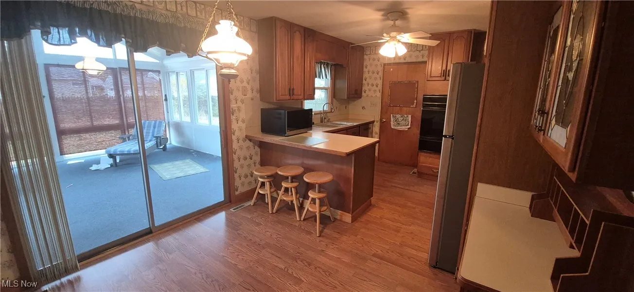 View from dining room into kitchen and sunroom
