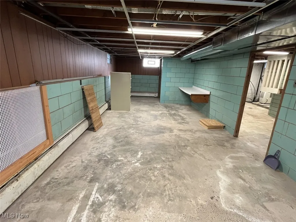 Below grade area featuring a baseboard heating unit