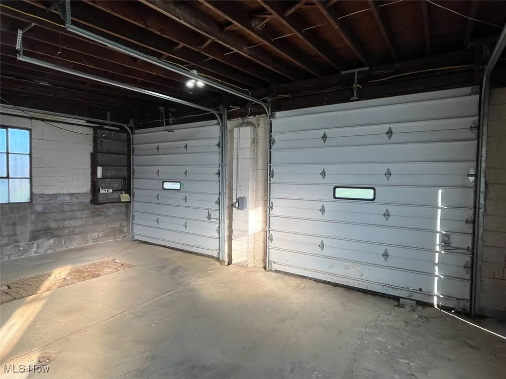 Garage featuring concrete block wall