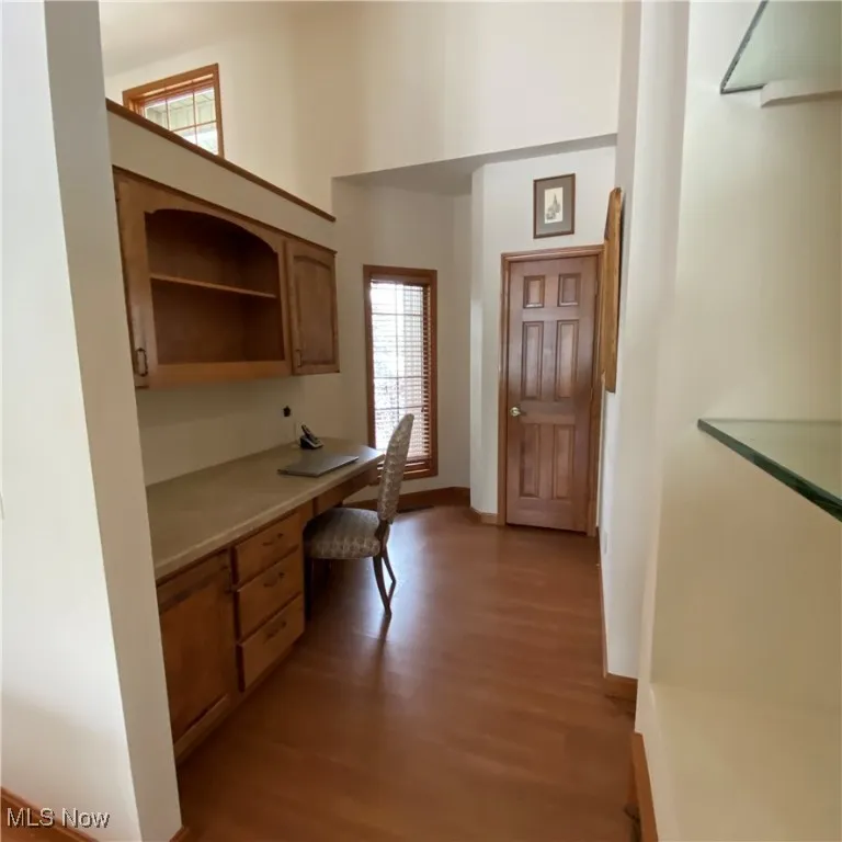 Office featuring built in desk and light wood-style​​‌​​​​‌​​‌‌​‌‌​​​‌‌​‌​‌​‌​​​‌​​ floors