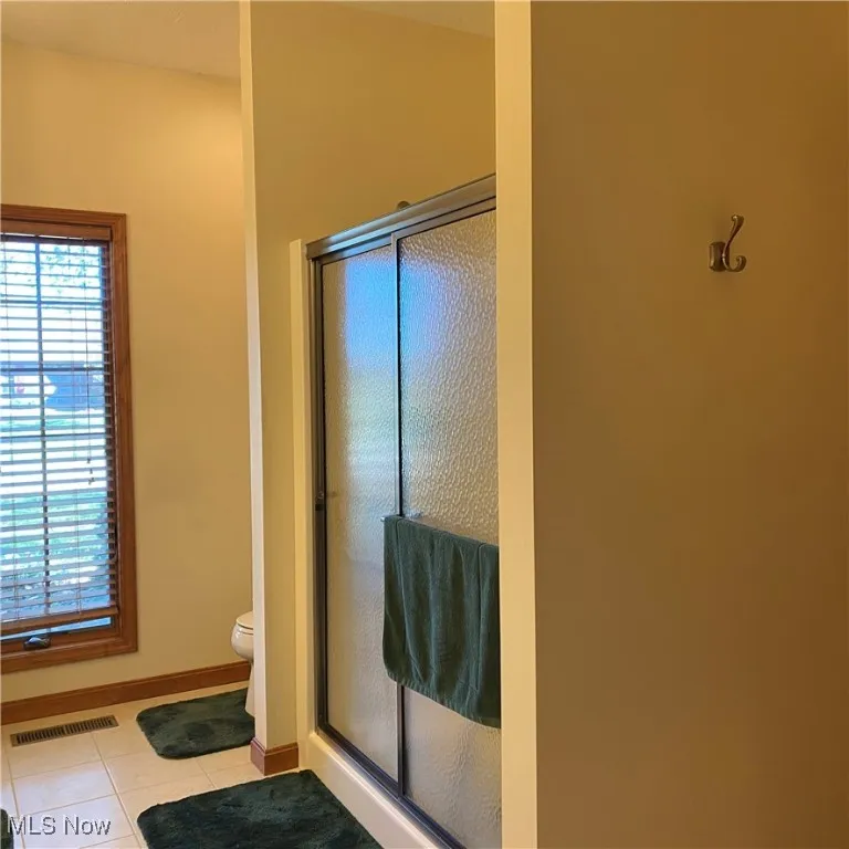 Master Full bathroom featuring light tile patterned floors and a shower stall
