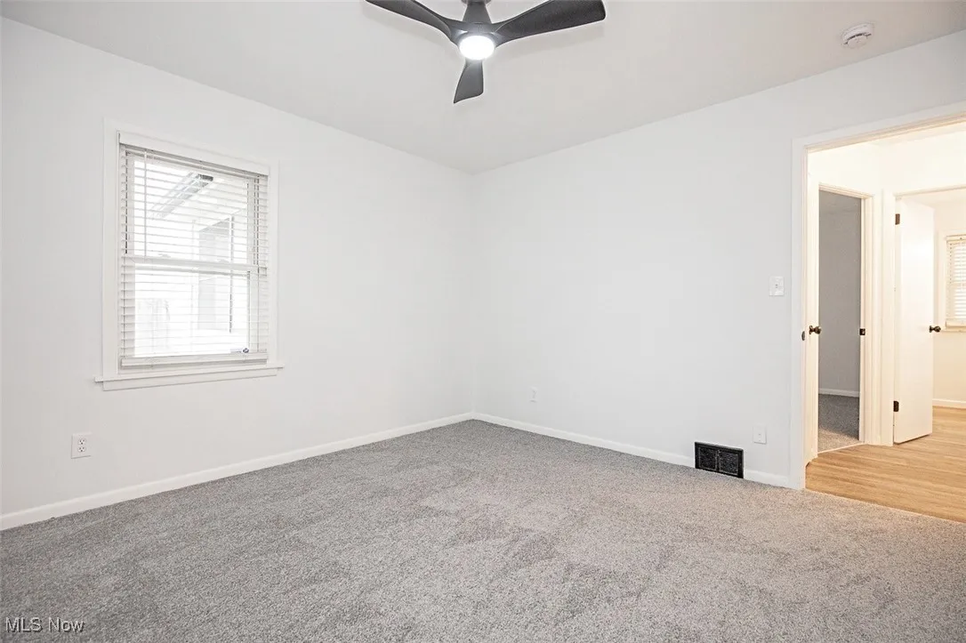 Bedroom featuring light carpet and a ceiling fan
