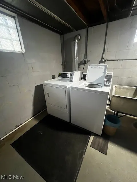 Washroom with finished concrete floors and independent washer and dryer