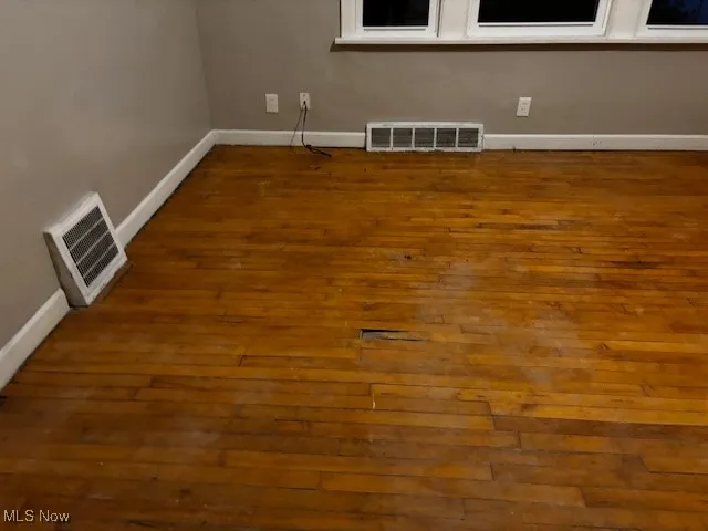 Bedoom with baseboards and dark wood finished floors