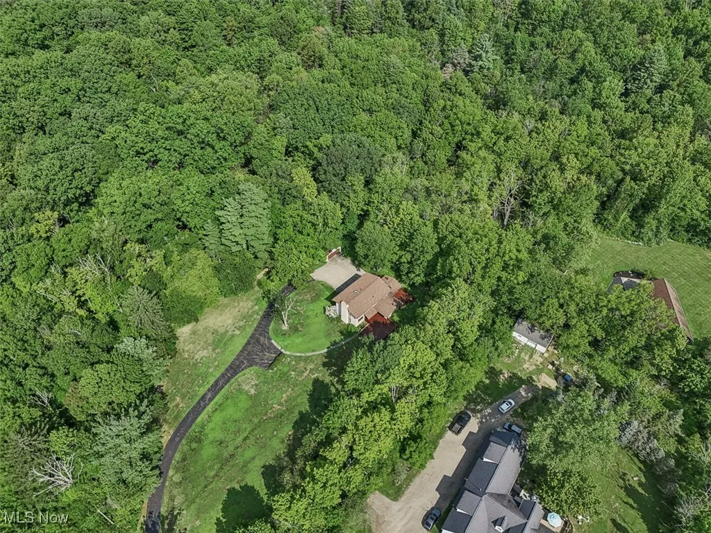 Aerial overview of property's location featuring a heavily wooded area