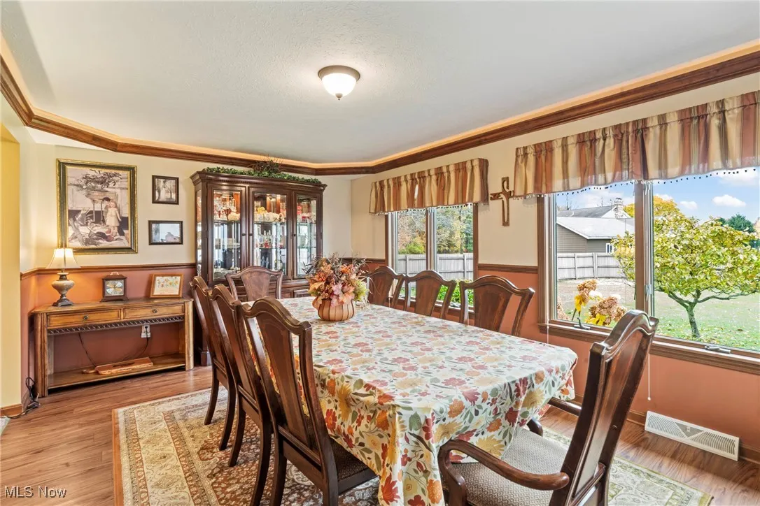 Dining space featuring wood finished floors and a textured ceiling