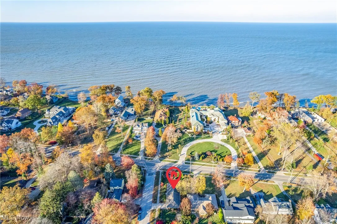 Aerial view of property's location with nearby suburban area and a nearby body of water