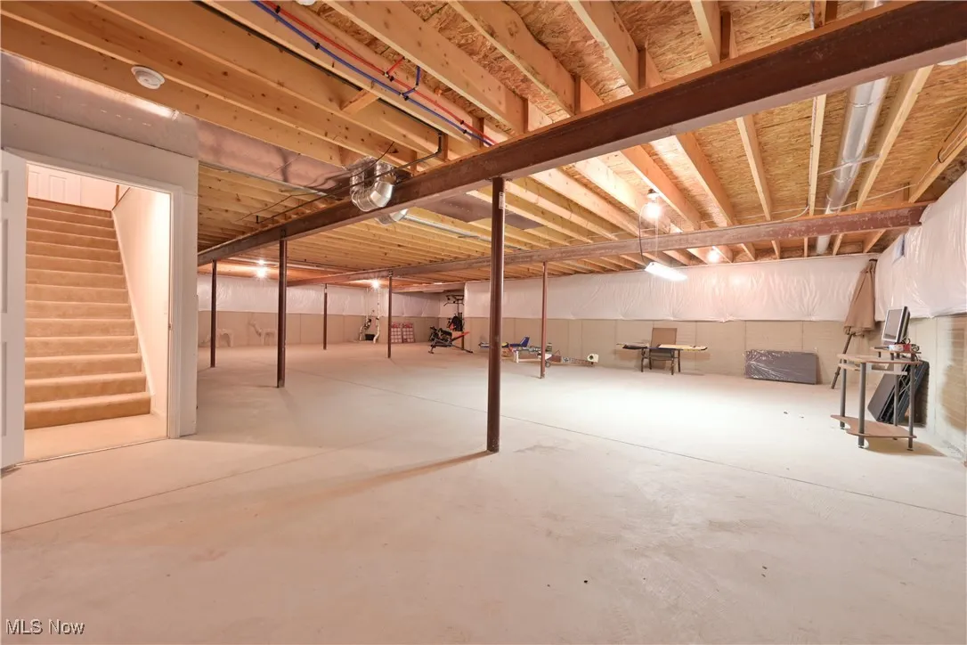 Unfinished basement with stairway