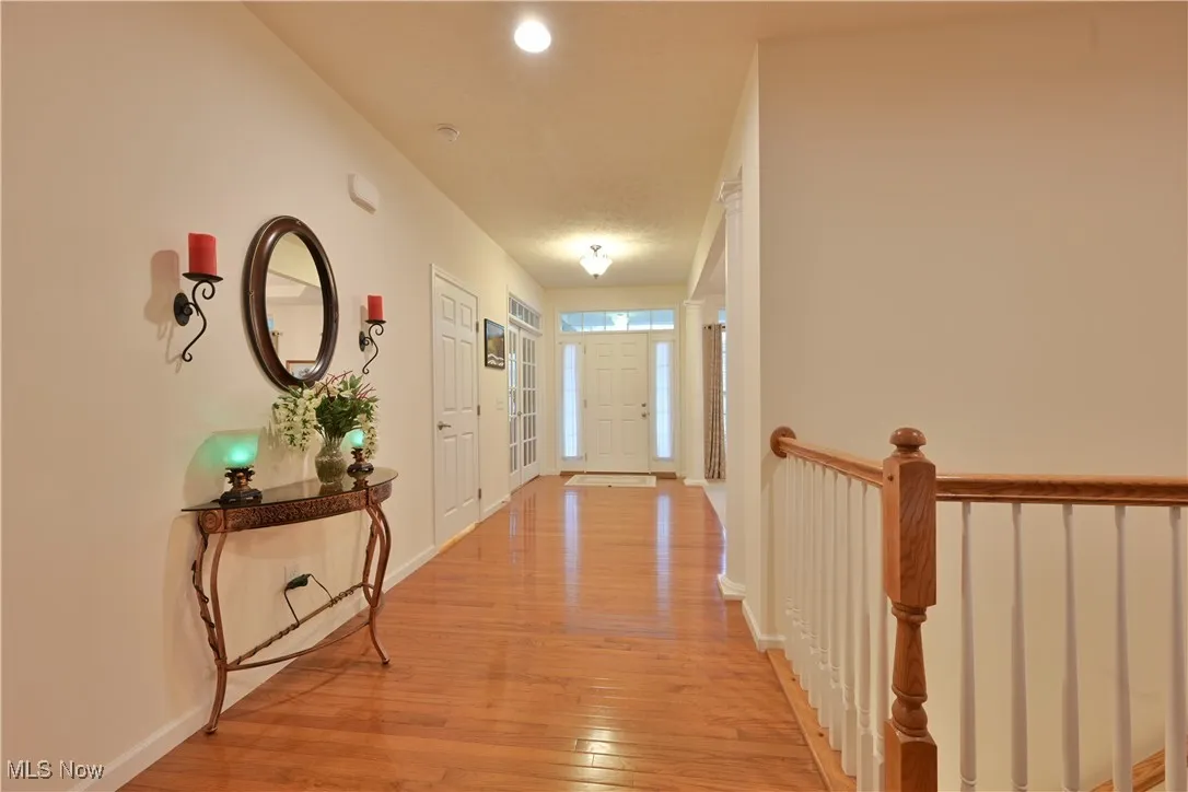Hall featuring light wood-style floors and recessed lighting
