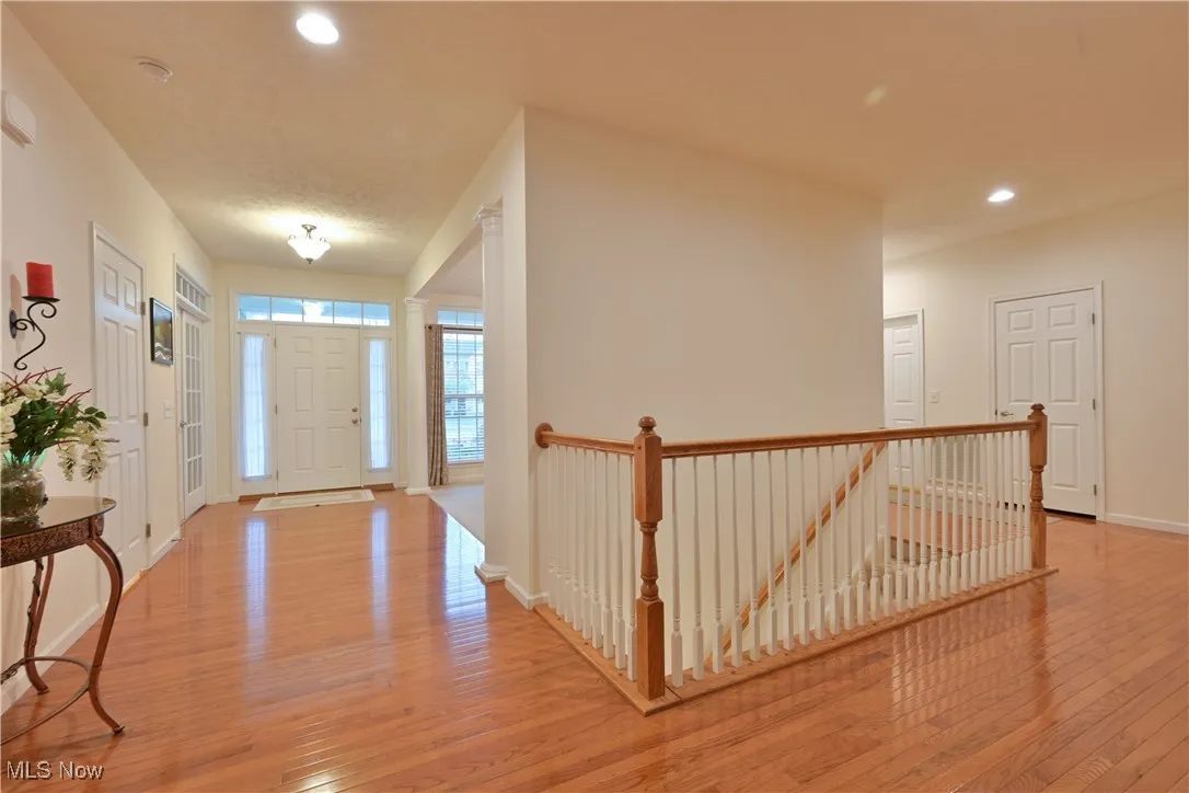 Entrance foyer with light wood finished floors and recessed lighting