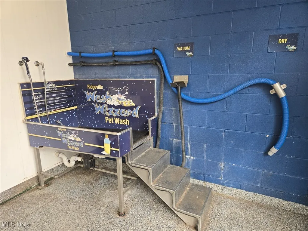 Detailed view of pet washing station and concrete block siding