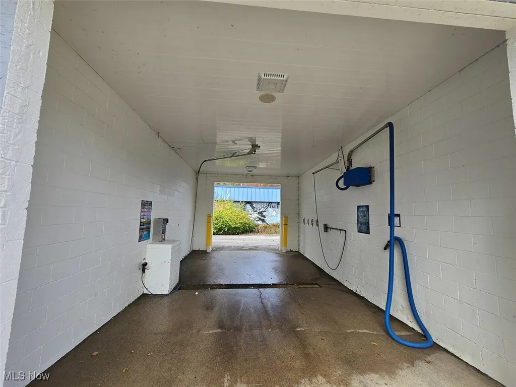 Garage featuring concrete block wall