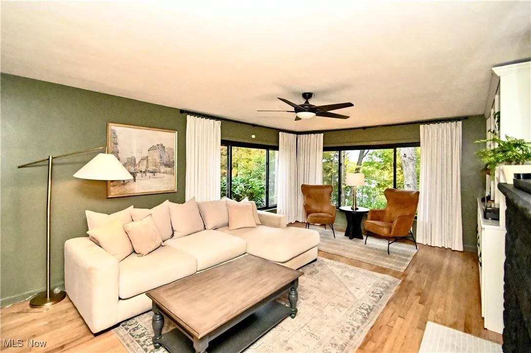 Living room featuring light wood-type flooring and ceiling fan
